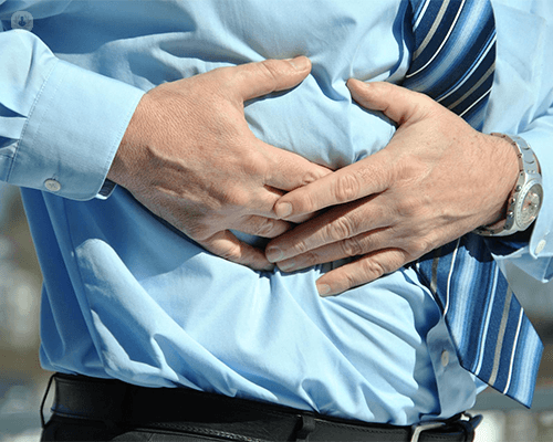 Man holding abdomen for chest pain